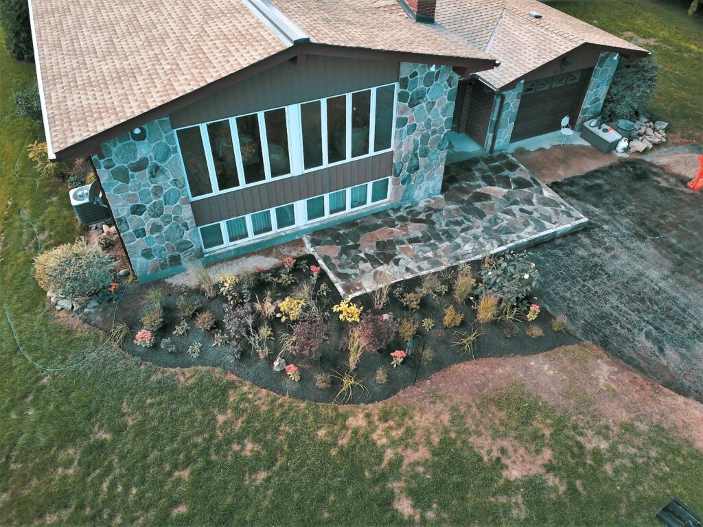Raised flagstone patio with native garden in Meaford by EcoCultures