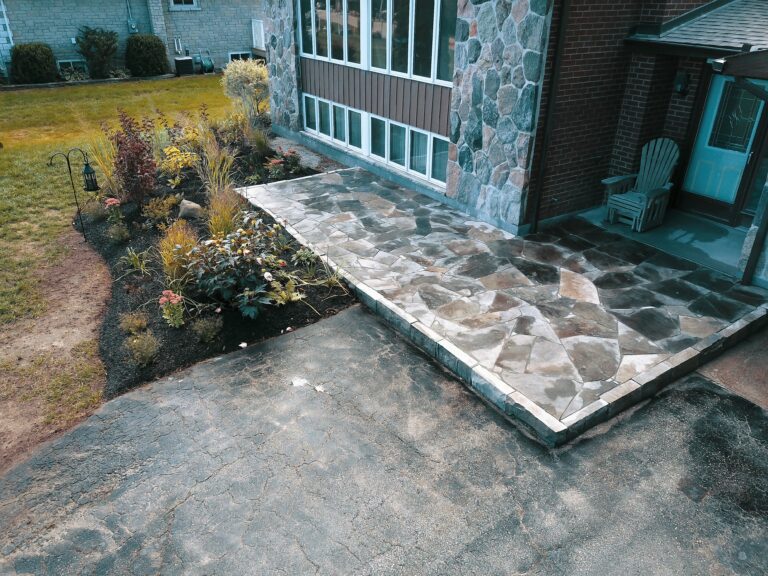 Raised flagstone patio with native garden in Meaford by EcoCultures