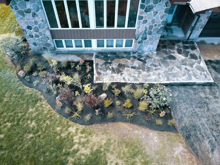 Raised flagstone patio with native garden in Meaford by EcoCultures