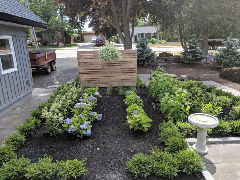 Paving stone front walkway with English garden in Meaford by EcoCultures