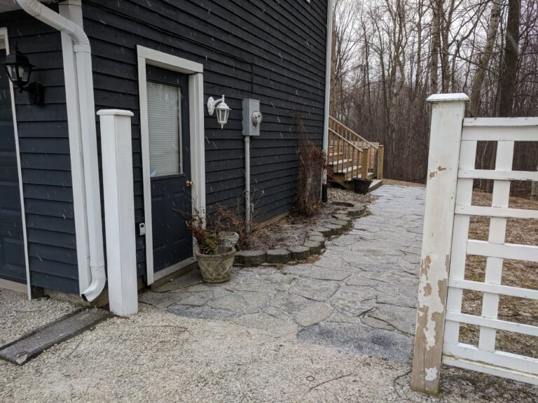 Flagstone patio with fire pit, retaining wall, and native gardens in Blue Mountains by EcoCultures