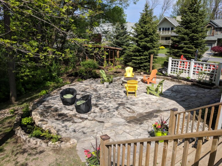 Flagstone patio with fire pit, retaining wall, and native gardens in Blue Mountains by EcoCultures