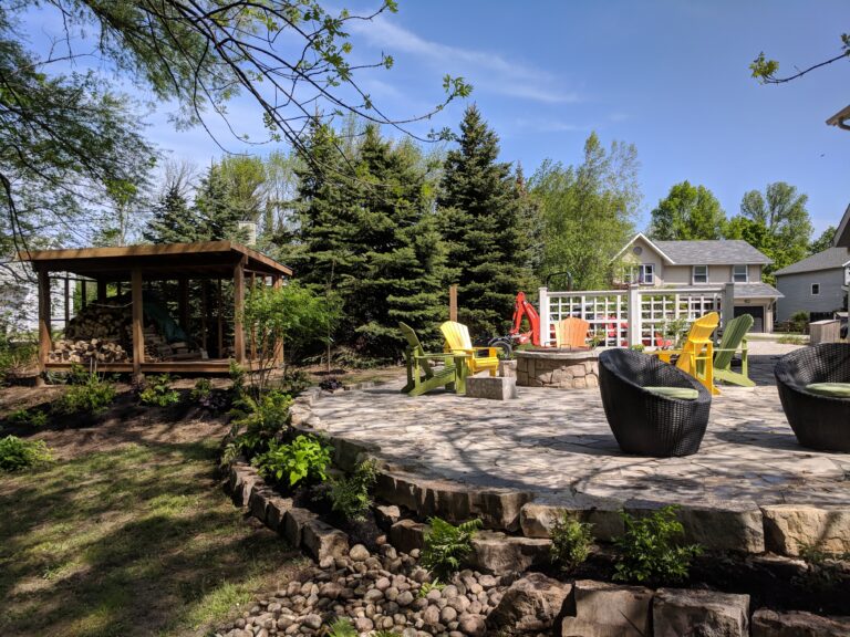 Flagstone patio with fire pit, retaining wall, and native gardens in Blue Mountains by EcoCultures