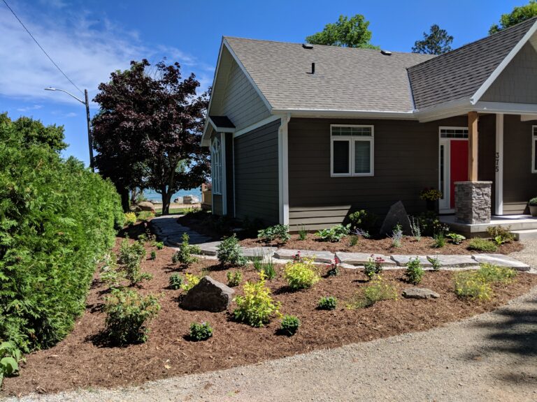 Stepping stone walkway with patio and attractant garden in Meaford by EcoCultures